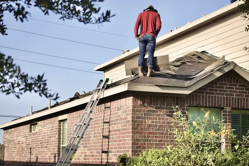 Professional roofer working on a residential roof in Sargent
